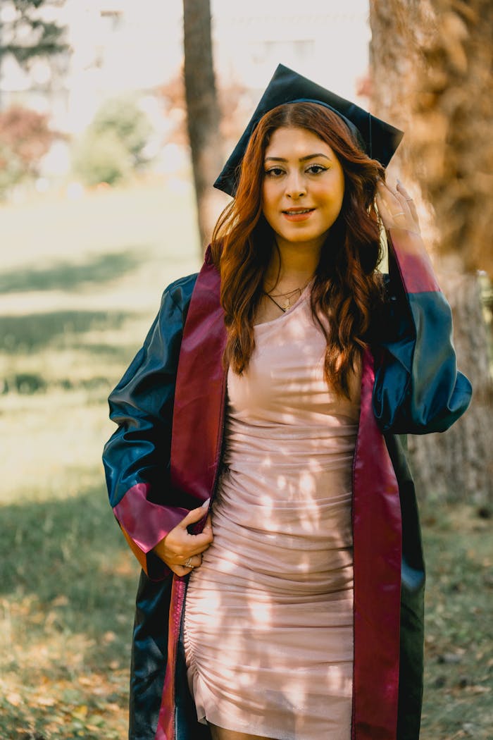 Crafting Captivating Headlines: Your awesome post title goes here Young woman celebrating graduation in a park with a smile and a graduation gown.